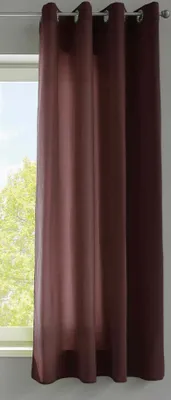 A close-up of a brown curtain hanging in front of a window.