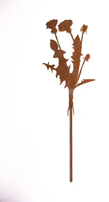 A rusty metal garden stake shaped like dandelions.
