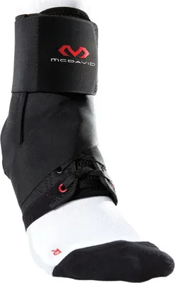 A black McDavid ankle brace with red accents, worn over a white sock with black toe and heel.