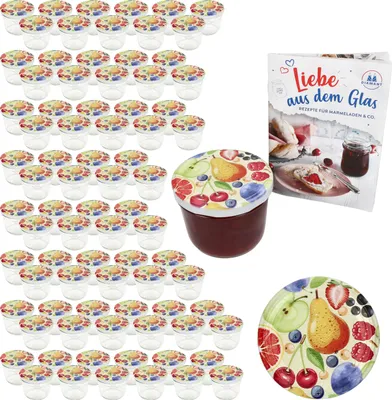 A collection of small jars with fruit-themed lids, a recipe book, and a decorative plate, all arranged on a white background.
