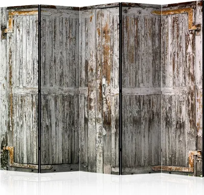 A room divider with a distressed wood door pattern.