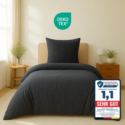 A bed with anthracite bedding is shown in a room setting.