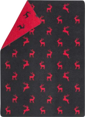 A folded blanket with a reindeer pattern.