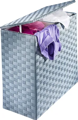 A laundry basket with clothes inside and the lid open.