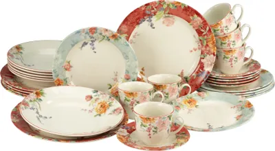 A collection of floral-patterned dinnerware, including plates, bowls, and cups.