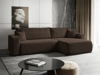 A modern living room with a brown sectional sofa, a black coffee table, and abstract art on the wall.