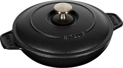 A black cast iron pot with a gold knob on the lid, shown from a slightly elevated angle against a white background.