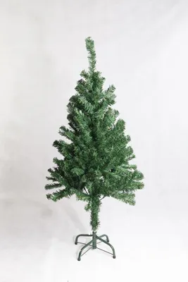 A green artificial Christmas tree on a stand against a white background.