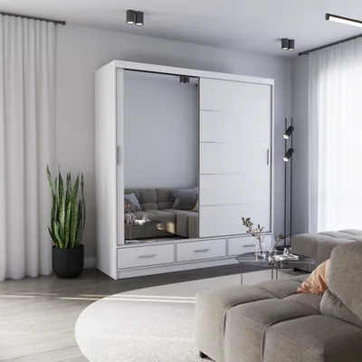 A modern living room with a large white sliding door wardrobe with mirrored doors, a sofa, and a coffee table.