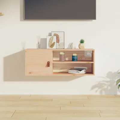 A wooden wall-mounted cabinet with decorative items on top and inside, placed on a wall above a wooden floor.