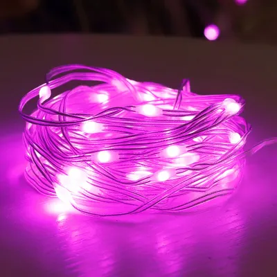 A close-up shot of a coiled string of pink LED lights.