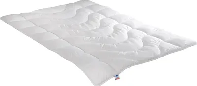 A white duvet is shown from a diagonal angle on a white background.