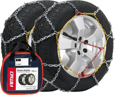 A pair of snow chains on tires, with a carrying bag in the foreground.