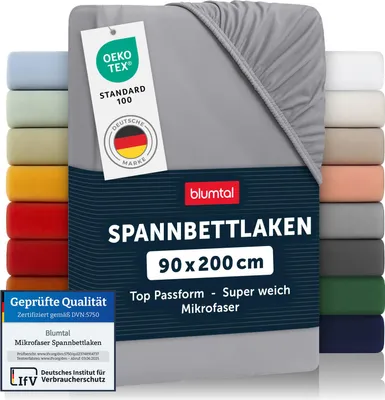 A folded gray fitted sheet with various color swatches on the left and right sides.