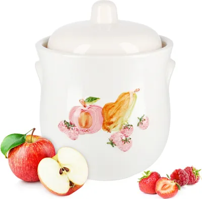 A white ceramic jar with a fruit illustration and fresh fruit around it.