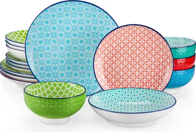 A collection of colorful ceramic plates and bowls with geometric patterns, arranged on a white background.