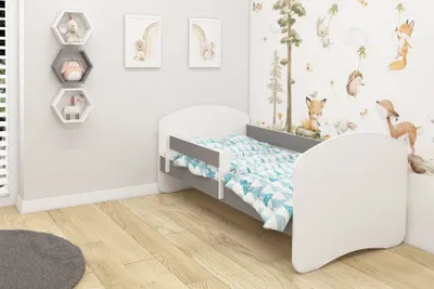 A child's bedroom with a bed and decorative elements.