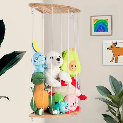 A wall-mounted shelf filled with stuffed animals in a room.