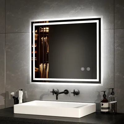 A modern bathroom vanity with a large illuminated mirror above a white sink.