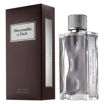 A bottle of Abercrombie & Fitch First Instinct Eau de Toilette for men and its packaging are displayed against a white background.