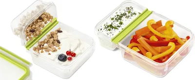 Two transparent food containers with green dividers, one filled with yogurt and granola, the other with sliced bell peppers.