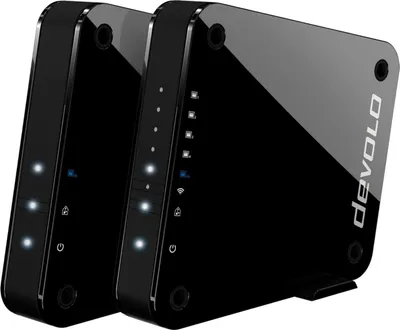 Two black Devolo GigaGate devices are shown side-by-side on a white background.