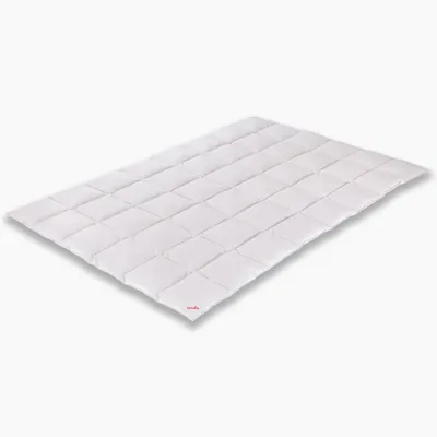 A white comforter laid out flat on a white background.