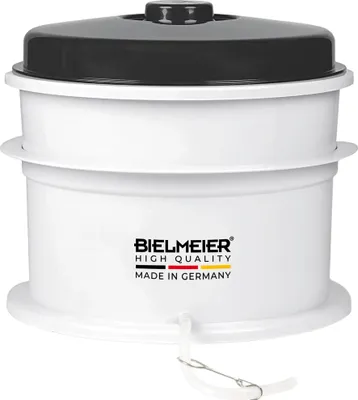 A white appliance with a black lid.