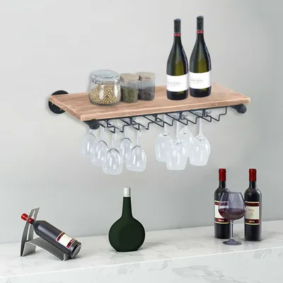 A wine rack with wine bottles and glasses displayed on a shelf and countertop.
