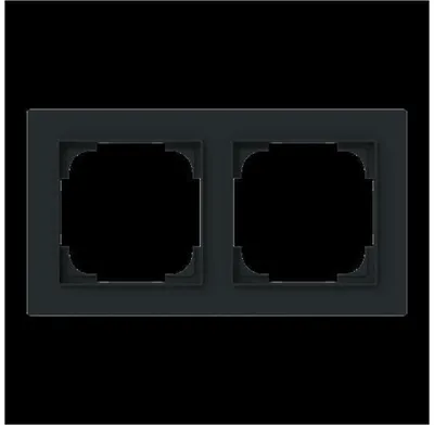 A dark frame with two square openings for electrical outlets or switches, set against a black background.