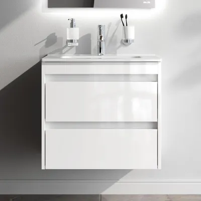 A white bathroom vanity with two drawers is mounted on a light gray wall.