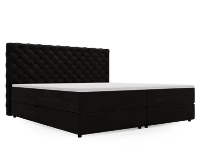 A black boxspring bed with a tufted headboard is shown against a white background.