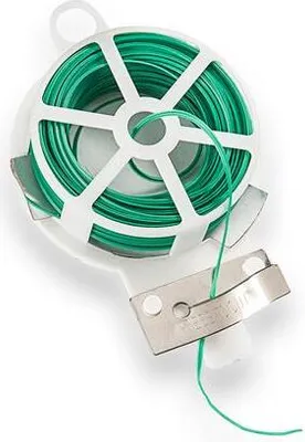 A spool of green garden wire on a white plastic holder with a metal cutting edge.