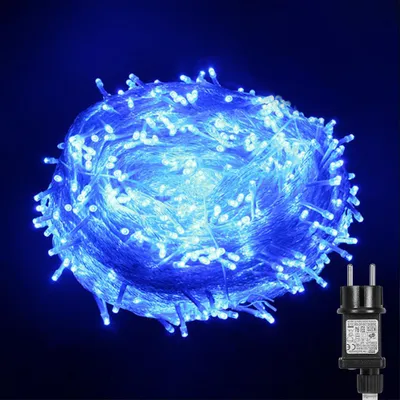 A coiled string of blue LED lights with a black power adapter in the bottom right corner.