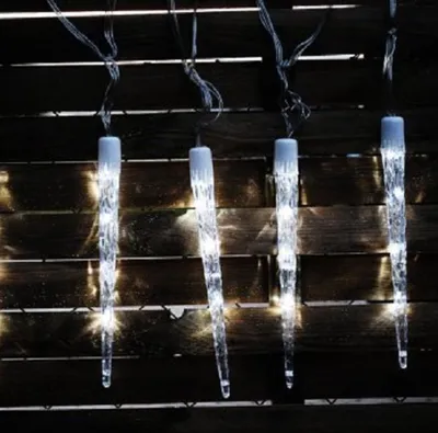 Icicle-shaped LED lights hanging against a dark, slatted background.