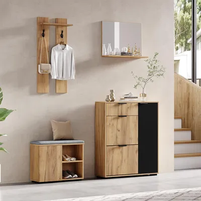 A hallway or entryway setting with a set of furniture including a coat rack, shoe cabinet, shoe bench, and mirror.