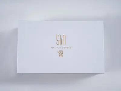 A white box with a gold logo and text.