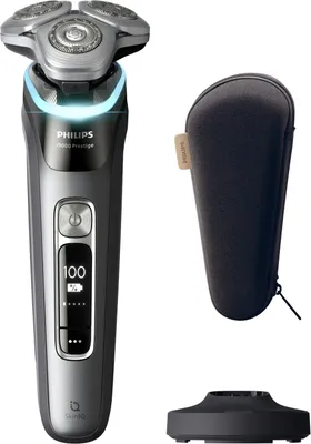 A Philips Series 9000 Prestige shaver, its charging stand, and a travel case are displayed against a white background.