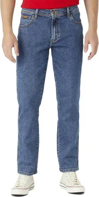 A person wearing blue jeans and white sneakers, standing against a white background.