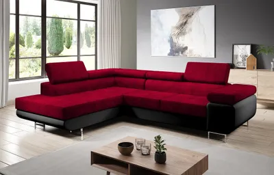 A modern living room with a sectional sofa, coffee table, and artwork on the wall.