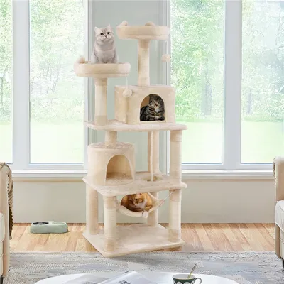 A cat tree with multiple levels and platforms, occupied by three cats, placed in a room with a large window showing greenery outside.