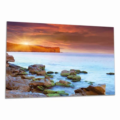 Produktbild von Wallario Herdabdeckplatte aus Glas, Größe 80 x 52 cm 1-teilig, Motiv Sonnenaufgang am Meer mit Landzunge und Felsen im Wasser