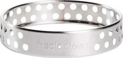 A close-up studio shot of a silver metal ring with multiple circular perforations.