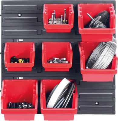 A pegboard-style organizer with multiple red bins containing various tools and materials.