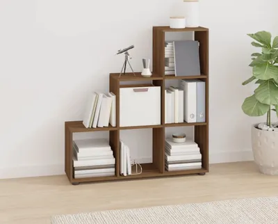 A brown wooden shelf unit with books and decorative items.