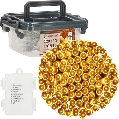 A product shot of LED string lights in a clear plastic container with a dark gray lid and handle, along with a separate battery pack and a pile of the illuminated lights.
