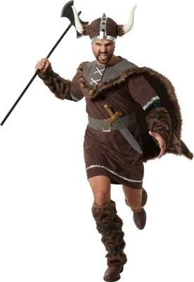 A man dressed in a Viking costume, holding an axe.