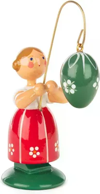 Immagine prodotto di Bambina con fiori, vestita con una gonna rossa e con un uovo di Pasqua verde su un supporto dorato, altezza 9 cm. Prodotto nuovo
