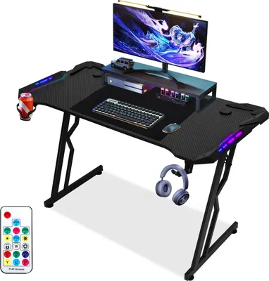 Immagine prodotto di Clanmacy tavolo da gioco a forma di Z scrivania per computer scrivania per ufficio tavolo da gioco con portabicchieri portacuffie tappetino per mouse LED e telecomando (140x60cm)