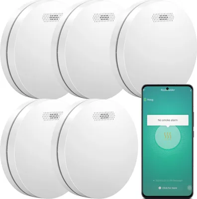 A set of white smoke detectors and a smartphone displaying a smoke alarm app.